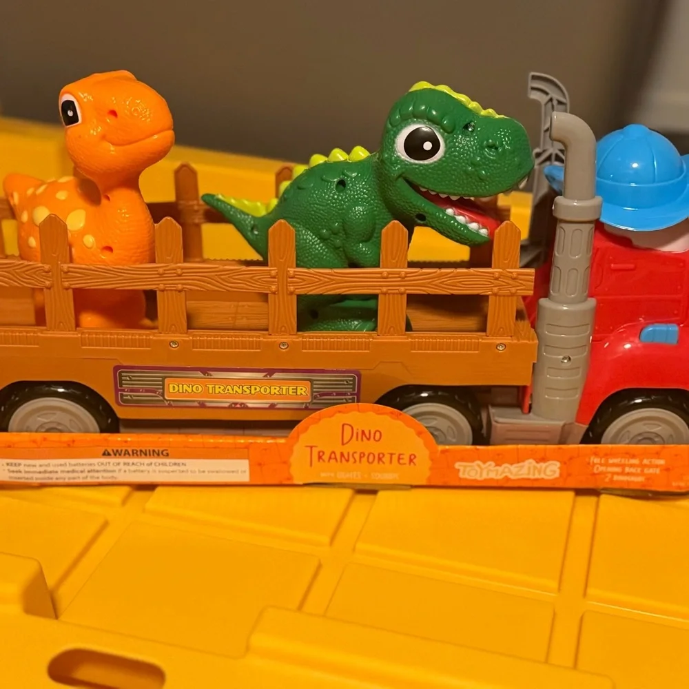 Dino Transporter Truck with Green and Orange Dinosaurs